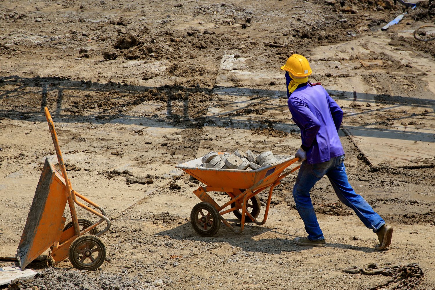 Construction Worker Holding a Wheelbarrow